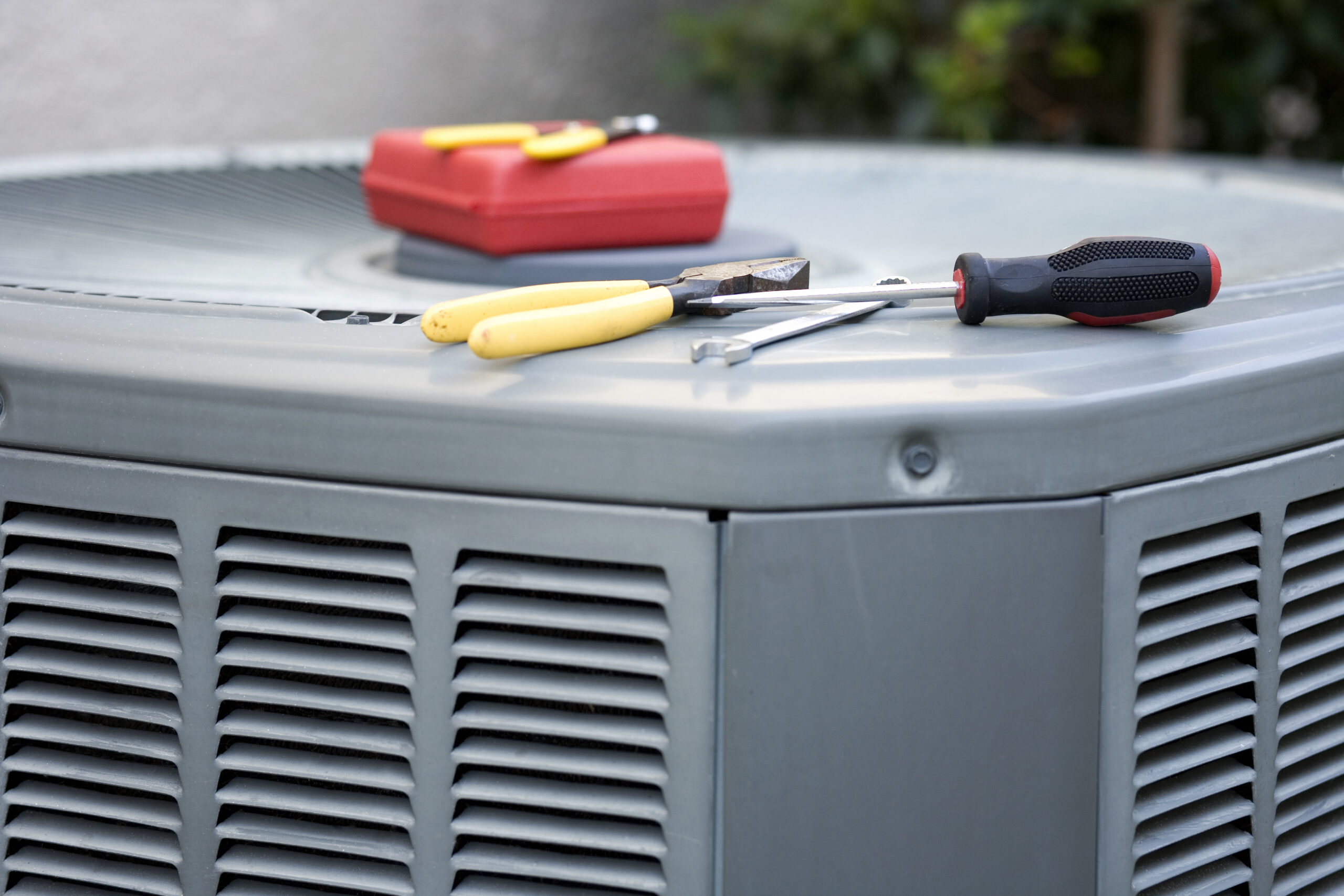AC unit with tools during repair